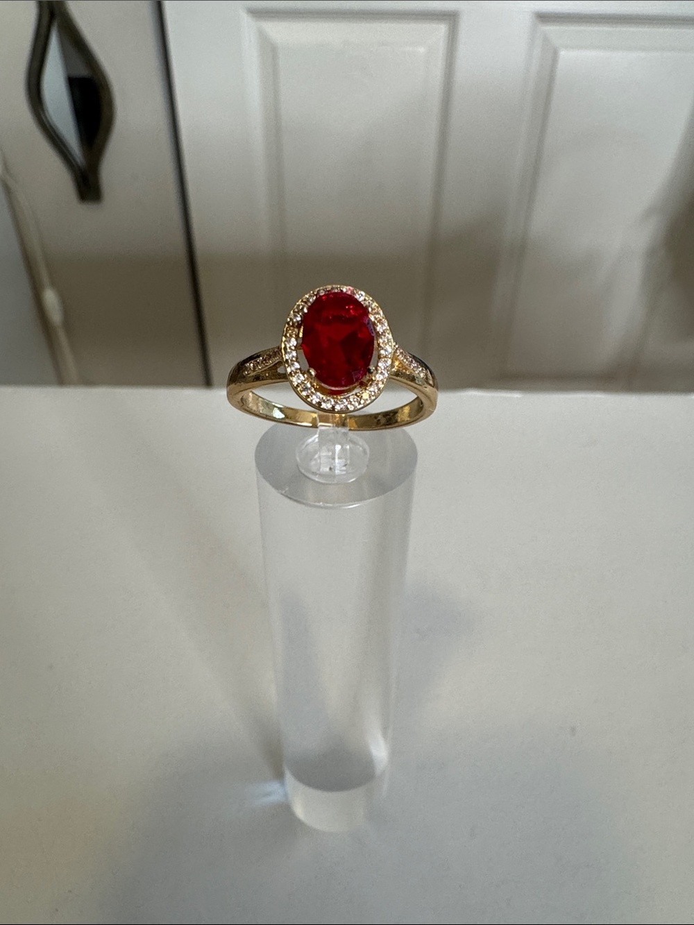 Red Oval Halo Ring in Gold Tone